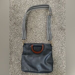 Black Leather Crossbody Bag with Brown Handle and Patterned Strap